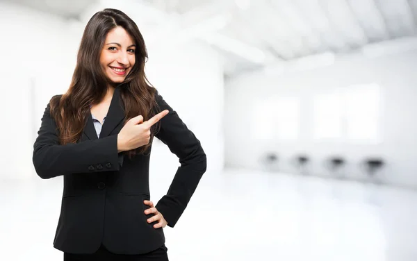 Businesswoman pointing her finger to the copyspace — Stock Photo, Image