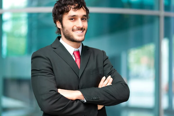 Businessman with arms folded at the office — Stock Photo, Image