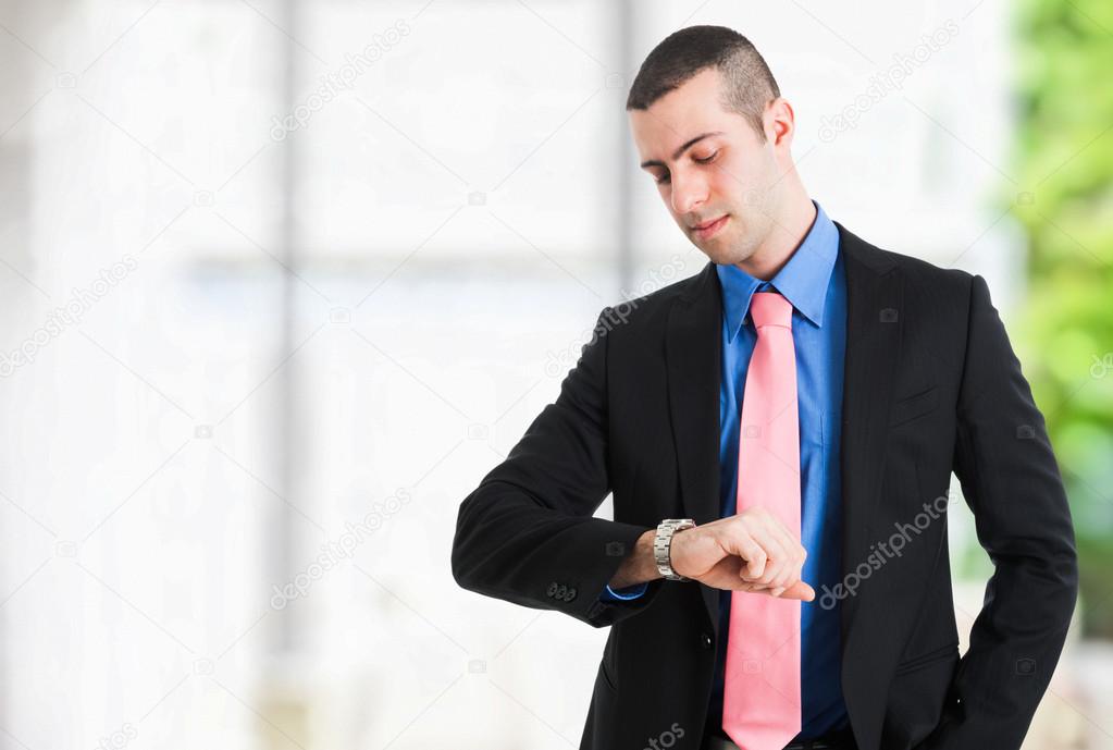 Businessman checking time on his watch