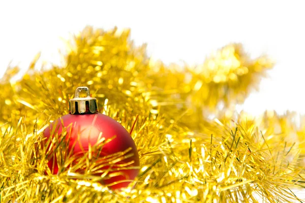 Red Christmas ball on a golden decoration — Stock Photo, Image
