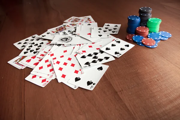 Playing cards near some poker chips — Stock Photo, Image