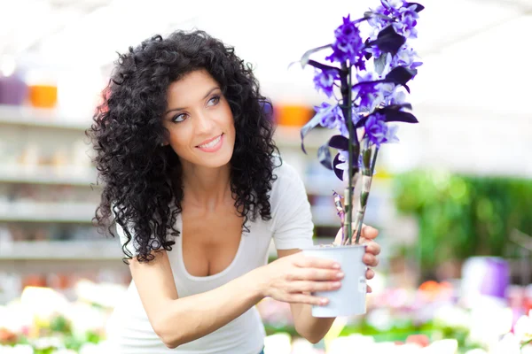 Krásná žena v květinové prostředí — Stock fotografie