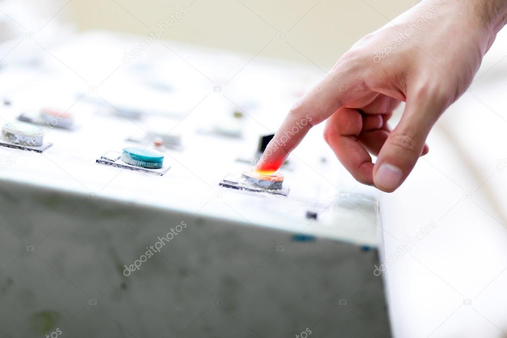Worker pressing the button on machine