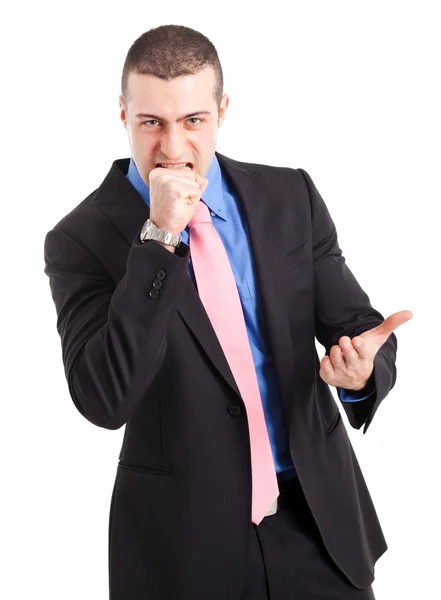 Furious businessman biting his hand — Stock Photo, Image