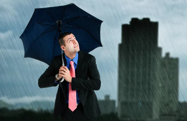Businessman under an umbrella — Stock Photo, Image
