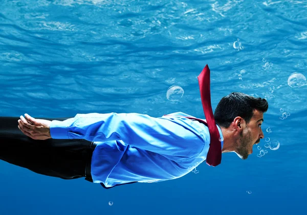 Businessman swimming underwater — Stock Photo, Image