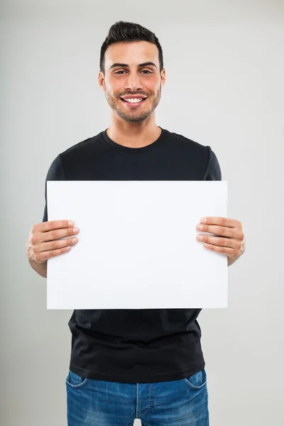 Άνθρωπος που κρατά έναν λευκό πίνακα — Φωτογραφία Αρχείου