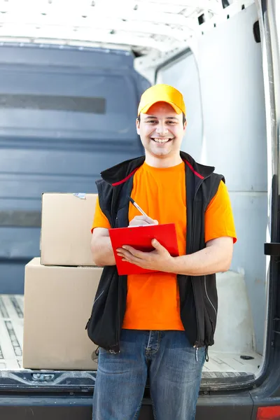 Smiling guy delivering a parcel — Stock Photo, Image