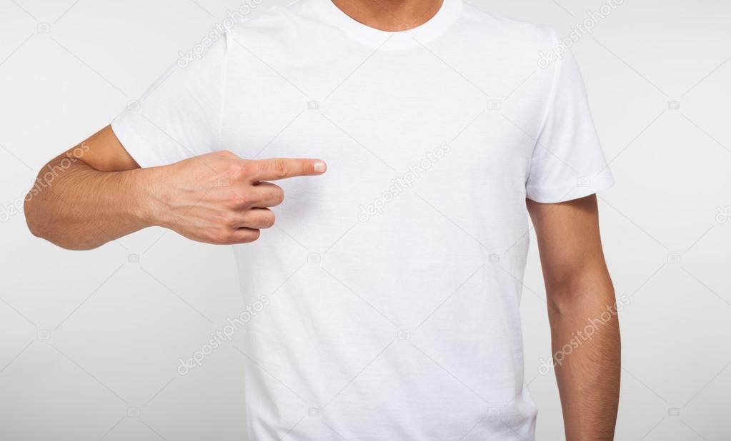 Man pointing his finger on a blank t-shirt