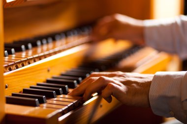 Man playing a church organ