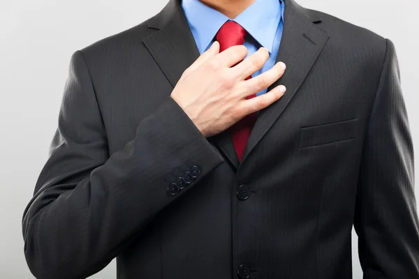 Businessman adjusting his tie — Stock Photo, Image