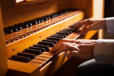 Man playing a church organ