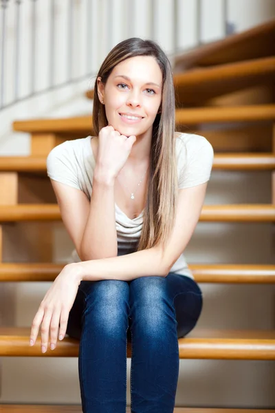 Lachende vrouw die zit op stappen — Stockfoto