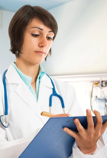 Médico escrevendo na área de transferência — Fotografia de Stock