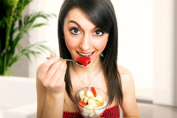 Woman eating a fruit cocktail — Stock Photo, Image