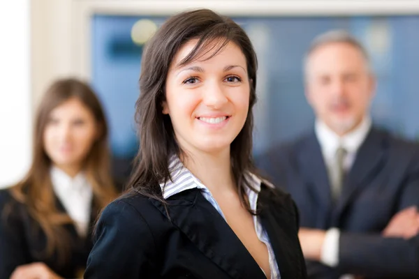 Businesswoman in front of her team — Stock Photo, Image