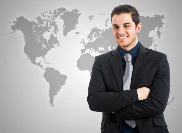 Businessman in front of a world map — Stock Photo, Image