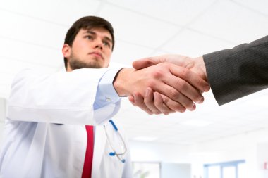 bir el sıkışma veren genç bir doktor