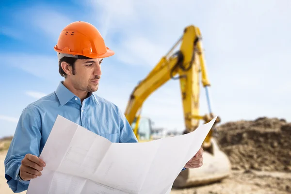 Architect at work in a construction site — Stock Photo, Image
