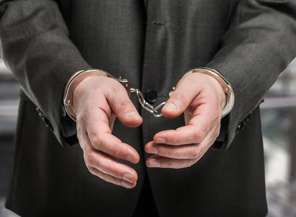 Manacles on criminal's hands — Stock Photo, Image