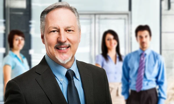 Businessman in front of a group of people — Stock Photo, Image