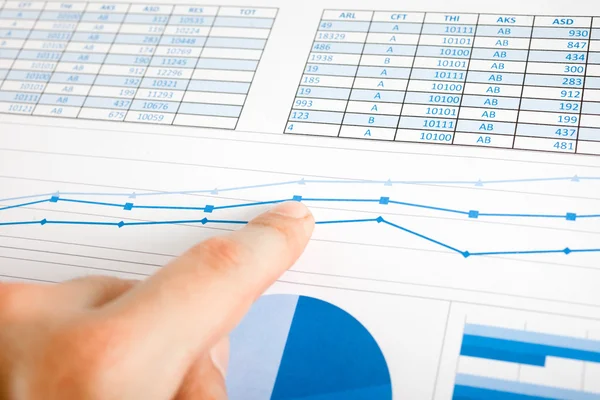 Finger pointing a business graph — Stock Photo, Image