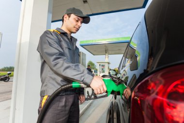 Man fueling up a car clipart
