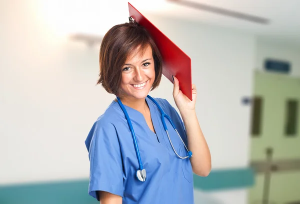 Nurse with clipboard in the clinic hall — Stock Photo, Image