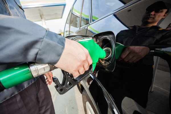 Man fueling up a car
