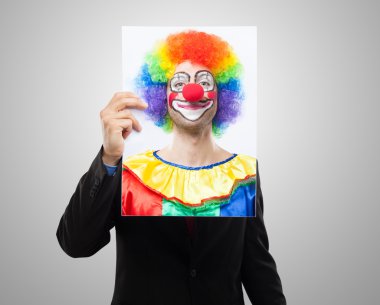 Man holding a clown face clipart
