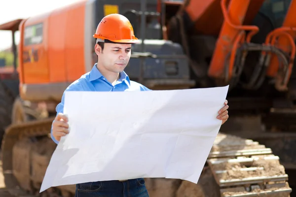 Architect looking at a blueprint — Stock Photo, Image