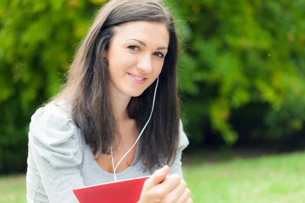 Женщина в парке слушает музыку — стоковое фото