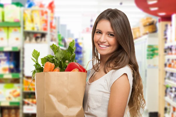 Woman holding a paper shopping bag — Stock Photo, Image