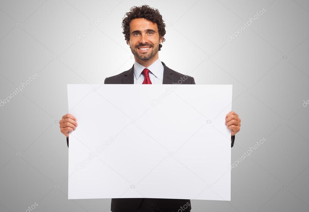 Man holding a blank board.