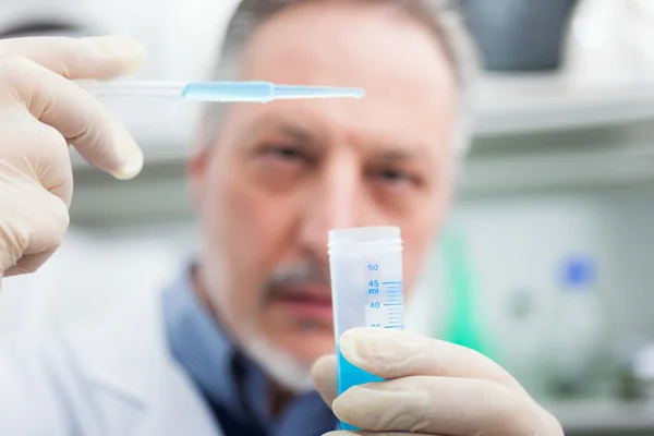 Researcher filling a test tube — Stock Photo, Image