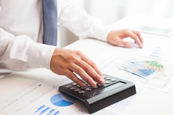 Businessman checking numbers on a document Royalty Free Stock Photos