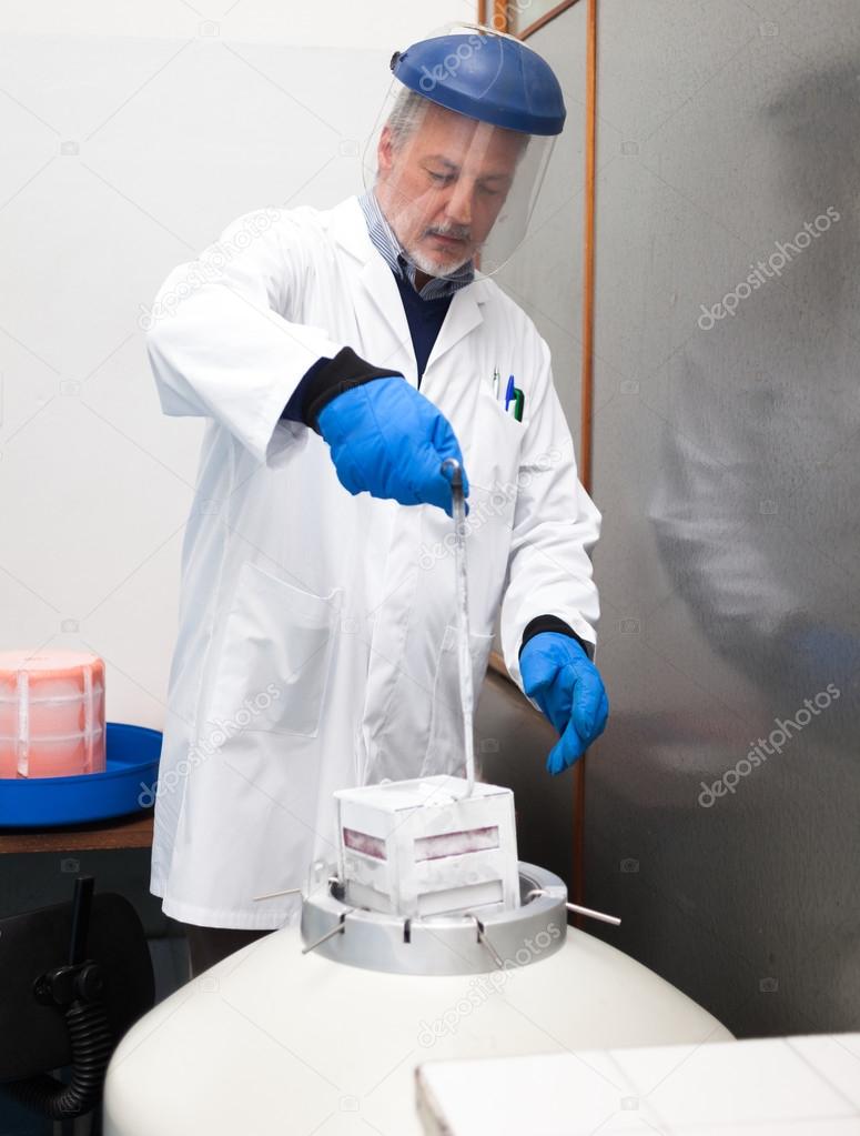 Scientist taking samples from container