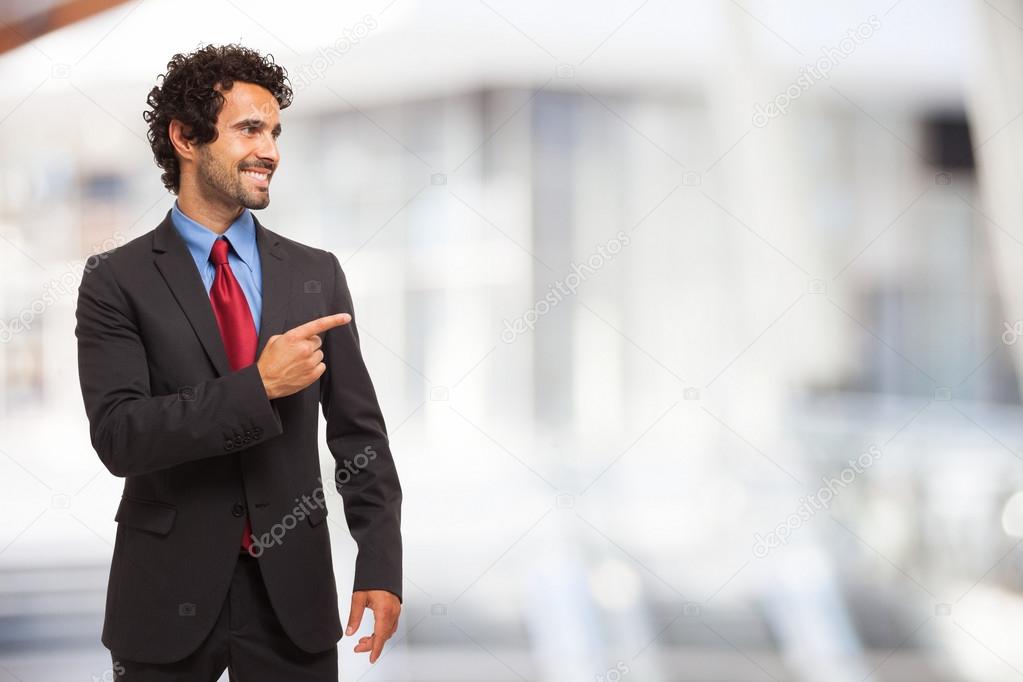 Businessman pointing his finger to the copy-space