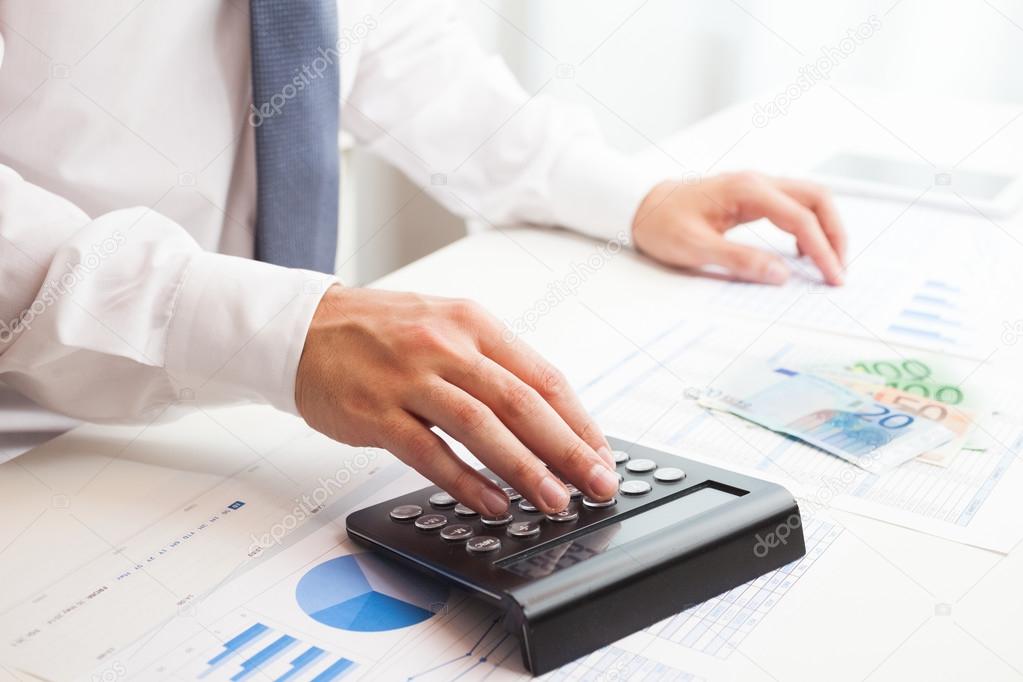 Businessman checking numbers on a document