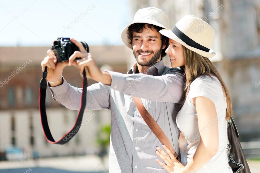 Couple taking a selfie in city