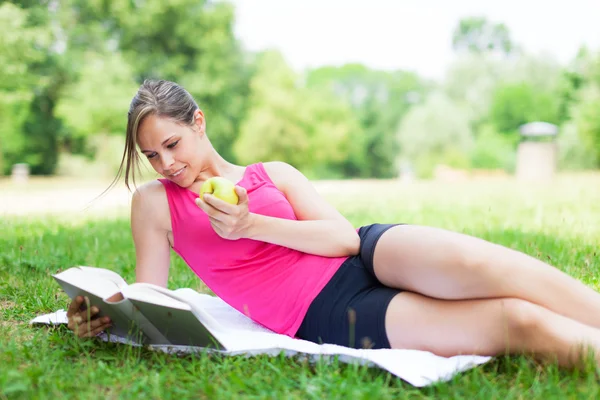 Žena čte knihu v parku — Stock fotografie