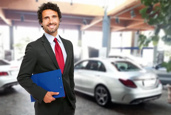 Handsome smiling car dealer — Stock Photo, Image
