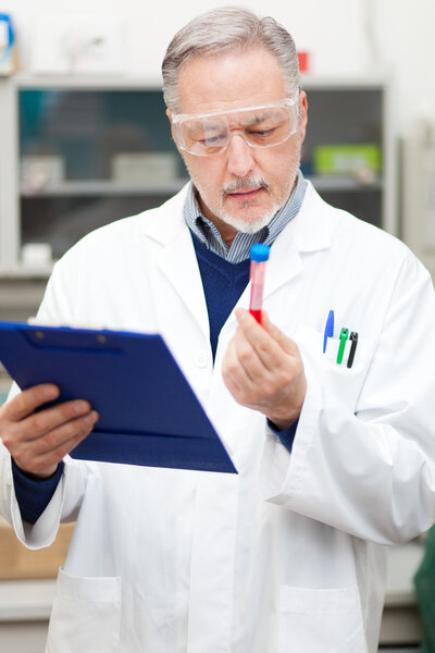 Scientists examining test tube