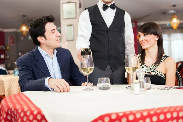 Waiter pouring wine in glass — Stock Photo, Image