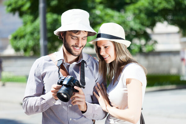 Tourist showing pictures to girlfriend