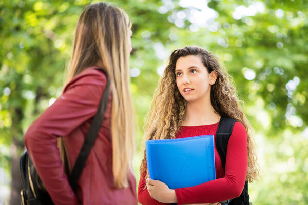 Female students having a conversation outdoor
