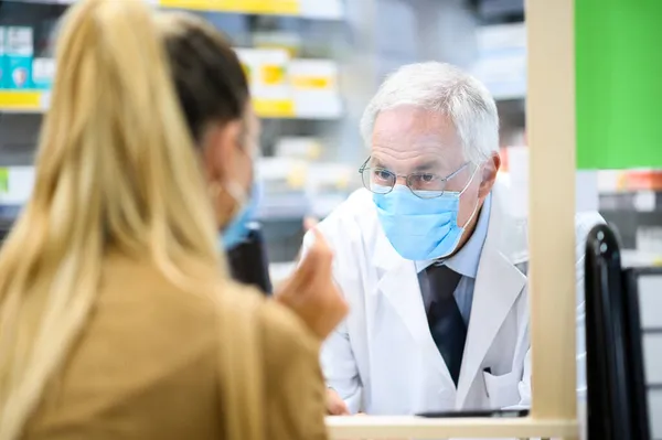 Farmacêutico Sênior Lidando Com Cliente Ambos Usando Máscaras Devido Coronavírus — Fotografia de Stock