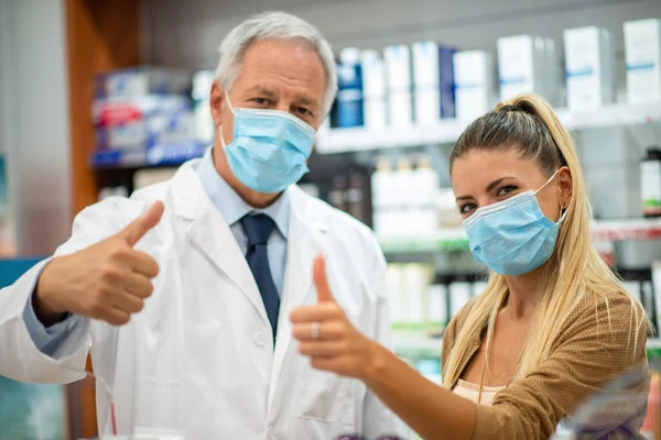 Happy Pharmacist Giving Thumbs Customer While Wearing Coronavirus Mask — Stock Photo, Image