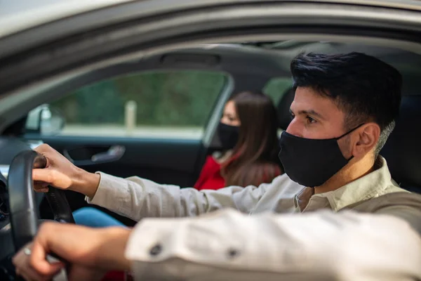 彼らの車の中で仮面の若いカップル Covidコロナウイルスの概念 — ストック写真