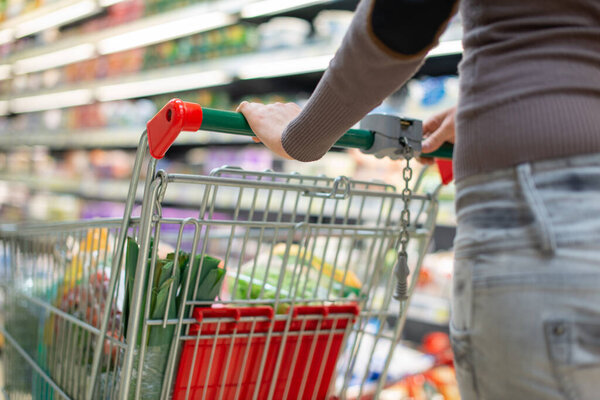 Close-up detail of a woman shopping in a supermarket